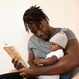 Dad reading to baby