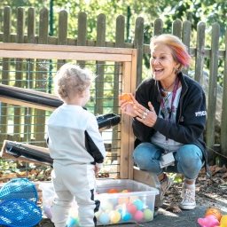 Family centre worker and toddler playing